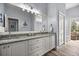 Bathroom with double sinks, granite countertops and outdoor view at 1107 Se 49Th Ave, Ocala, FL 34471