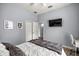 Bright bedroom with wood-look floors and a mounted television on the wall at 1107 Se 49Th Ave, Ocala, FL 34471