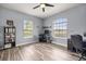 Bright bedroom with wood-look flooring, neutral walls, ceiling fan, and lots of natural light at 1107 Se 49Th Ave, Ocala, FL 34471