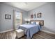 Well-lit bedroom featuring wood-look floors and neutral wall color at 1107 Se 49Th Ave, Ocala, FL 34471