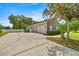 Exterior shot showcasing the home's stone accents, a paved driveway and manicured landscaping at 1107 Se 49Th Ave, Ocala, FL 34471