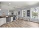 Bright kitchen featuring stainless steel appliances and wood-look flooring, adjacent to a patio and pool at 1107 Se 49Th Ave, Ocala, FL 34471