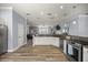 Open-concept kitchen with stainless steel appliances, granite countertops, and seamless flow into the living area at 1107 Se 49Th Ave, Ocala, FL 34471