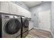 Well-equipped laundry room with stainless steel washer and dryer and plenty of cabinet space at 1107 Se 49Th Ave, Ocala, FL 34471