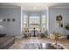 Seating area featuring neutral tones, bay window, and wood-look tile floors at 1107 Se 49Th Ave, Ocala, FL 34471