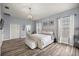 Spacious main bedroom with a king bed, wood-look flooring, and stylish decor at 1107 Se 49Th Ave, Ocala, FL 34471