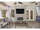 Inviting outdoor living room with fireplace, television, ceiling fans, and comfortable seating at 1107 Se 49Th Ave, Ocala, FL 34471