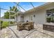A spacious patio area featuring brick pavers, an outdoor dining table, and a view of the yard at 1107 Se 49Th Ave, Ocala, FL 34471
