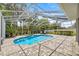 Backyard pool surrounded by screened enclosure and lush landscaping at 1107 Se 49Th Ave, Ocala, FL 34471