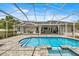 Beautiful backyard pool with screened enclosure, brick pavers, spa, and outdoor living space at 1107 Se 49Th Ave, Ocala, FL 34471