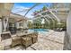 Screened-in pool area features brick pavers, a lounge area, outdoor dining, and a beautiful view of the backyard at 1107 Se 49Th Ave, Ocala, FL 34471