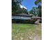 Backyard featuring a lush green lawn, mature bushes, and a single story home at 1325 Nw 73Rd Ter, Ocala, FL 34482