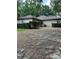 Backyard featuring single story home, AC unit, trimmed hedges, and mixed terrain at 1325 Nw 73Rd Ter, Ocala, FL 34482