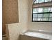 Corner soaking tub featuring a window at 1325 Nw 73Rd Ter, Ocala, FL 34482