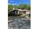 Single story home featuring architectural windows and a front yard with trees and bushes at 1325 Nw 73Rd Ter, Ocala, FL 34482