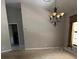 Open living room featuring a decorative chandelier and large window at 1325 Nw 73Rd Ter, Ocala, FL 34482