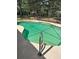 Clear blue in-ground pool featuring a metal ladder and screened in enclosure at 1325 Nw 73Rd Ter, Ocala, FL 34482