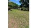 Large, grassy yard with trees, fencing, and a home in the background at 1325 Nw 73Rd Ter, Ocala, FL 34482
