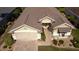 Aerial view of the home's entrance, driveway, manicured front yard and updated roof at 14004 Se 94Th Ave, Summerfield, FL 34491