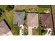 Aerial view showcasing the roofs of houses with manicured lawns and driveways, providing a glimpse of neighborhood at 14004 Se 94Th Ave, Summerfield, FL 34491