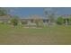 Spacious backyard featuring verdant lawn, manicured landscaping, and a charming white picket fence at 14004 Se 94Th Ave, Summerfield, FL 34491