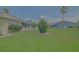 Expansive backyard view featuring a flowering tree, well-kept lawn, and charming white picket fence at 14004 Se 94Th Ave, Summerfield, FL 34491