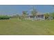 The home has a beautiful backyard with lush grass, palm trees and a charming white picket fence at 14004 Se 94Th Ave, Summerfield, FL 34491