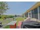 Landscaped backyard featuring a white picket fence, lush lawn, and patio with outdoor seating at 14004 Se 94Th Ave, Summerfield, FL 34491