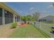 Enjoy this grassy backyard with a screened in patio and a charming white picket fence at 14004 Se 94Th Ave, Summerfield, FL 34491