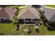 Aerial view of a home's backyard with well-maintained landscaping and screened-in lanai at 14004 Se 94Th Ave, Summerfield, FL 34491