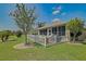 This inviting backyard features a well-maintained lawn and a white picket fence for added charm at 14004 Se 94Th Ave, Summerfield, FL 34491