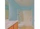 Well-lit bathroom featuring a bathtub and oak vanity at 14004 Se 94Th Ave, Summerfield, FL 34491