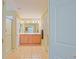 Bright bathroom featuring double vanity, tiled floor, shower, and linen closet at 14004 Se 94Th Ave, Summerfield, FL 34491