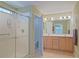 Spacious bathroom with a shower, double vanity, and adjoining toilet room at 14004 Se 94Th Ave, Summerfield, FL 34491