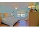Bright bedroom with laminate floors, ceiling fan, and natural light at 14004 Se 94Th Ave, Summerfield, FL 34491