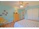 Comfortable bedroom with light blue walls, wood flooring, closet, and a relaxing chair at 14004 Se 94Th Ave, Summerfield, FL 34491