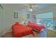 This cozy bedroom has two twin beds with wood flooring, a ceiling fan, and natural light at 14004 Se 94Th Ave, Summerfield, FL 34491