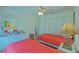This charming bedroom features two beds, wood floors, a ceiling fan, and bright natural light at 14004 Se 94Th Ave, Summerfield, FL 34491