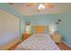 Cozy bedroom features light blue walls, wood flooring, and a comfortable bed with side tables at 14004 Se 94Th Ave, Summerfield, FL 34491