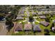 Aerial view of a residential community featuring well-maintained homes, landscaping, and neighborhood streets at 14004 Se 94Th Ave, Summerfield, FL 34491