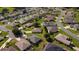 Aerial view of a residential neighborhood with well-maintained homes, lush greenery, and winding streets at 14004 Se 94Th Ave, Summerfield, FL 34491
