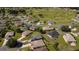 Aerial view of a residential community near a golf course with well-maintained homes and landscaping at 14004 Se 94Th Ave, Summerfield, FL 34491