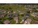Aerial view of a well-kept residential community near a golf course with neat landscaping and winding streets at 14004 Se 94Th Ave, Summerfield, FL 34491