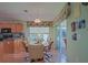 Cozy dining area adjacent to kitchen featuring wood floors, modern decor and sliding glass doors to patio at 14004 Se 94Th Ave, Summerfield, FL 34491
