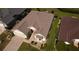 Aerial view of a charming home featuring a manicured lawn and well-maintained architectural design at 14004 Se 94Th Ave, Summerfield, FL 34491