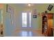 Inviting foyer featuring neutral tile flooring, and a decorative glass front door at 14004 Se 94Th Ave, Summerfield, FL 34491