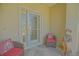 Close up of the entrance to this home with chairs, statue and decorative glass door at 14004 Se 94Th Ave, Summerfield, FL 34491