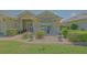 Charming home with lovely chairs by the front window, surrounded by lush landscaping at 14004 Se 94Th Ave, Summerfield, FL 34491