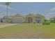 Charming single-story home with a two car garage, lush green lawn, and manicured landscaping at 14004 Se 94Th Ave, Summerfield, FL 34491