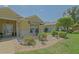 Charming front yard with well-maintained garden beds, decorative rocks, and a cozy seating area at 14004 Se 94Th Ave, Summerfield, FL 34491
